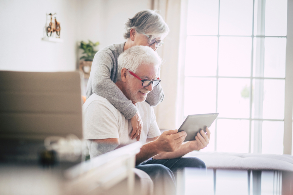 Man and woman with glasses and tablet